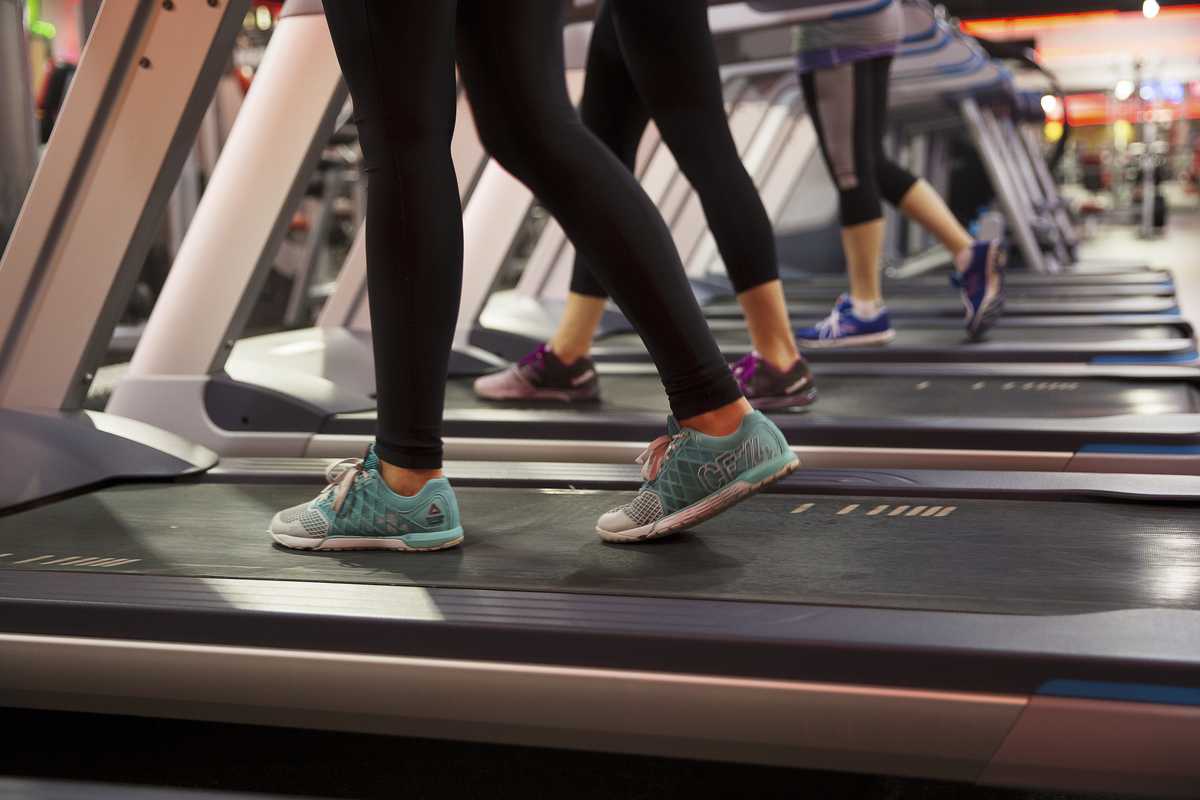 Three people running on threadmills