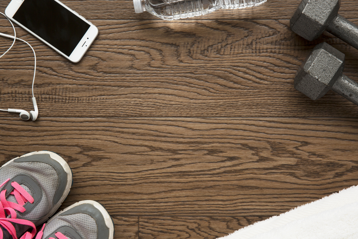 Sneakers, water, phone, earphones and dumbbells