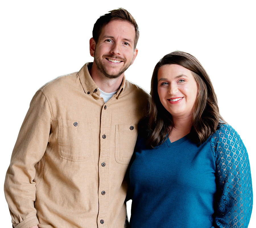 A smiling man and woman stand side by side