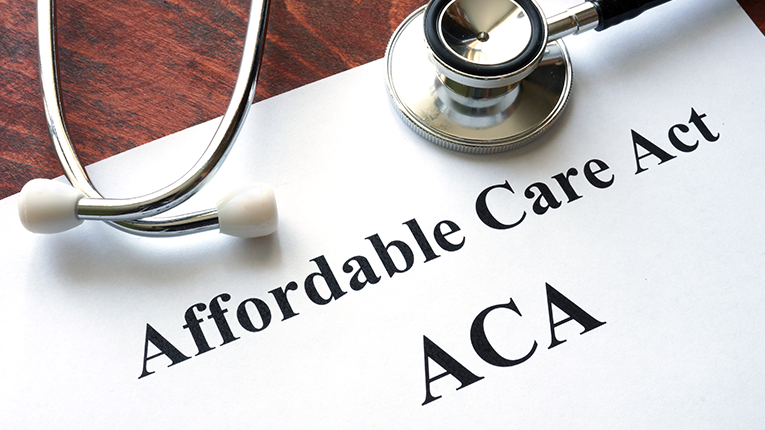 Document titled Affordable Care Act (ACA) with a stethoscope resting on it
